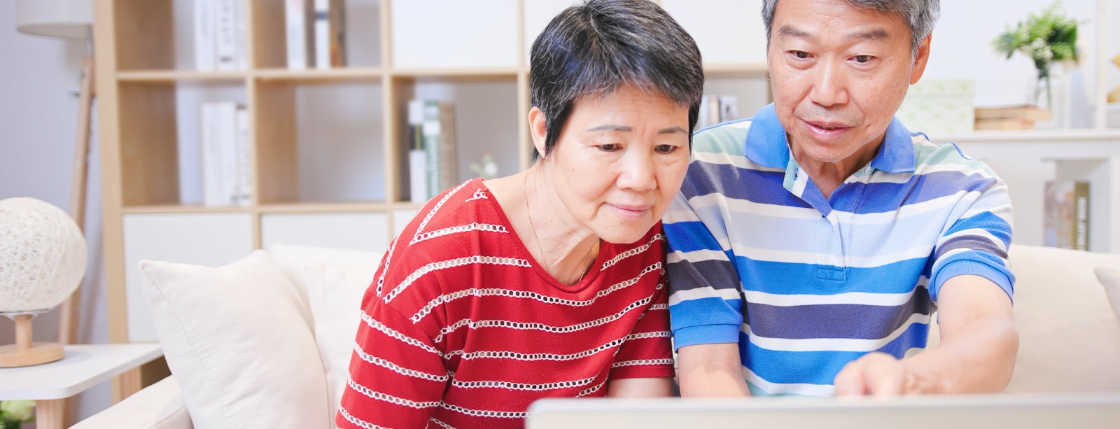 Image of a senior couple looking at laptop